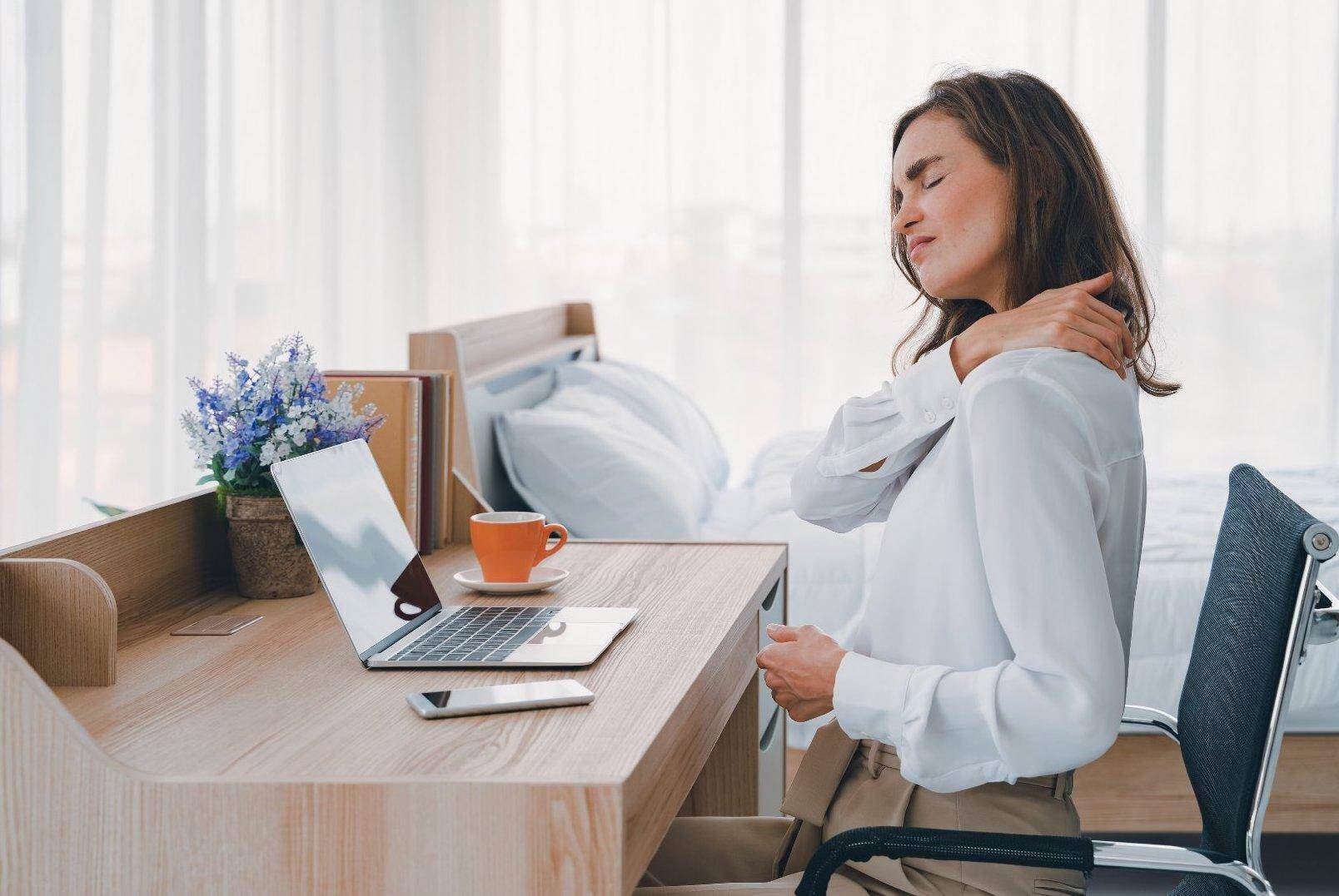 A woman massaging her shoulder that has been injured by a repetitive stress injury related to work in South Fulton, Georgia