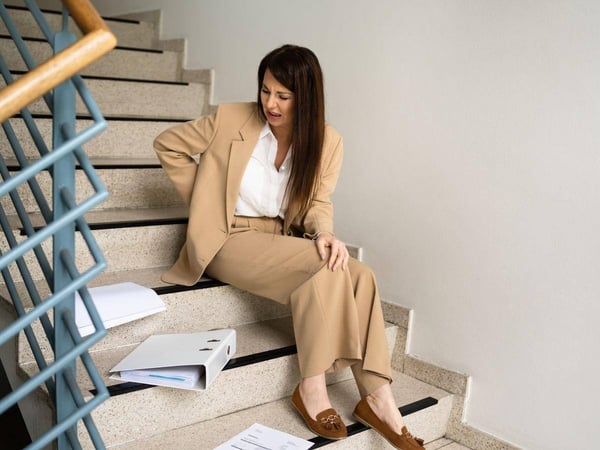 Woman-Drops-Documents-After-Slipping-on-Stairs