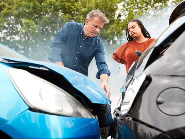 Man and a woman discussing the aftermath of their car accident