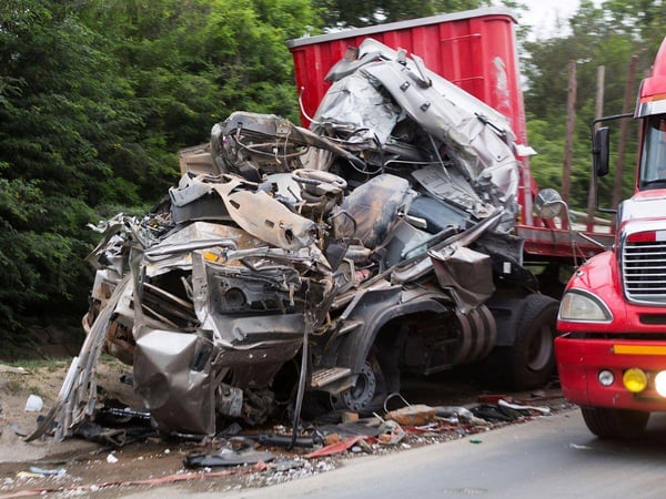 red semi-truck damaged in an accident