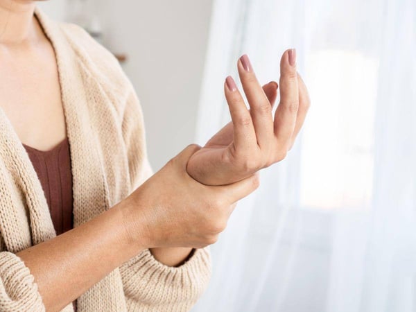 Woman assessing a hurt left wrist.