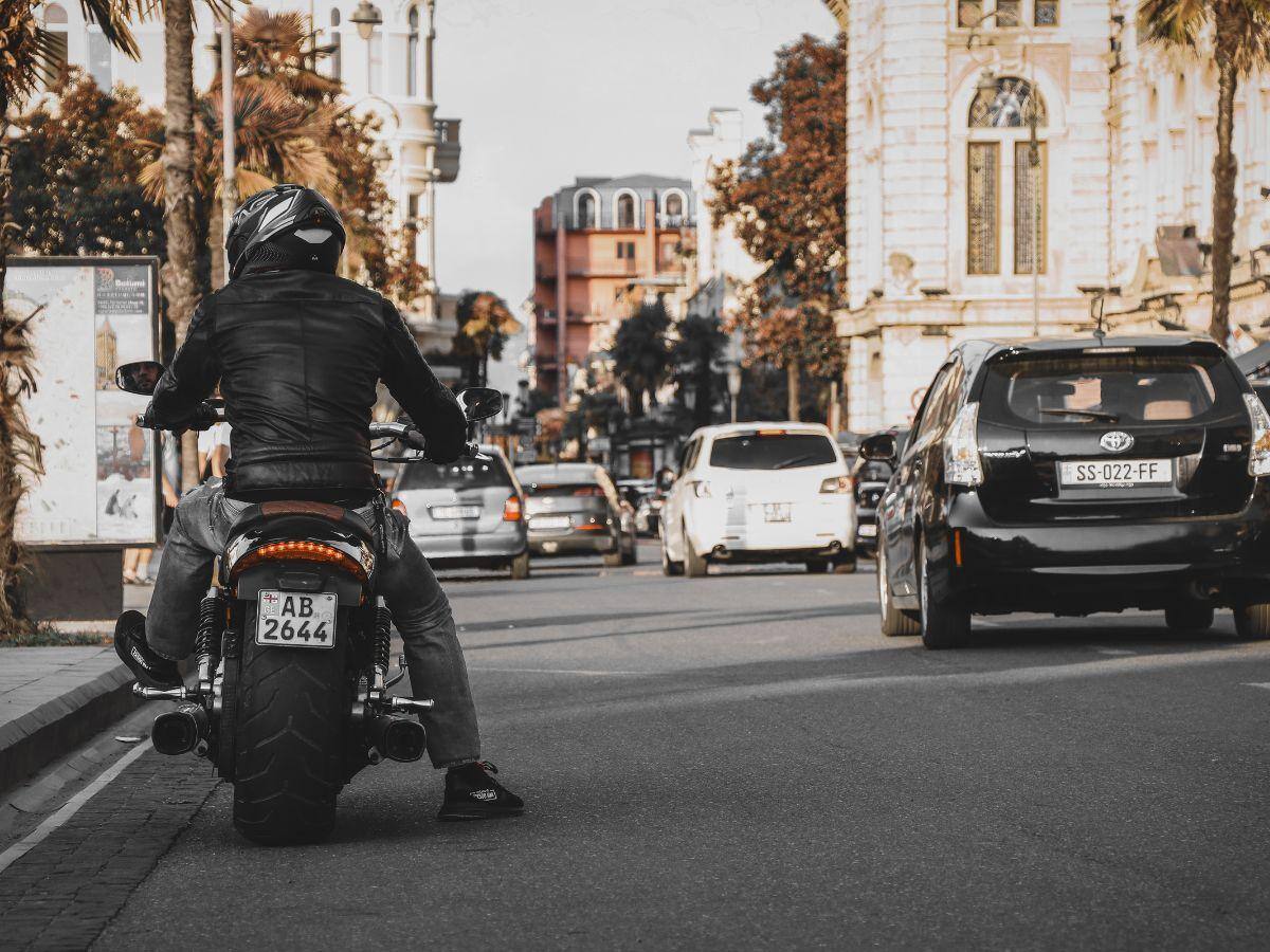 Motorcycle Rider in Atlanta Observing Traffic on a Main Road